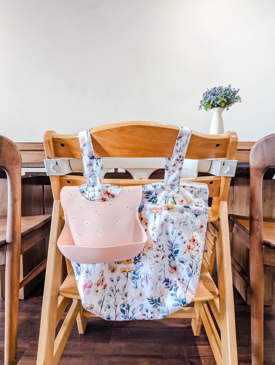 double-pocket floral wetbag hanging from high chair